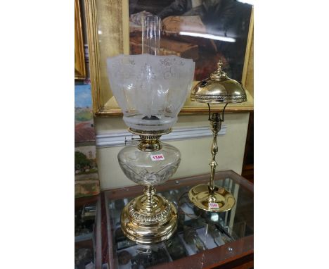 A brass oil lamp, with glass reservoir and etched glass shade, height excluding chimney 46cm.&nbsp; 