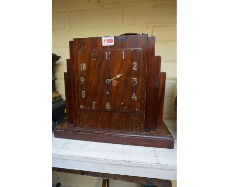 An Art Deco walnut mantel clock,&nbsp;with single fusee, 30.5cm high, (s.d.), with pendulum.&nbsp; 