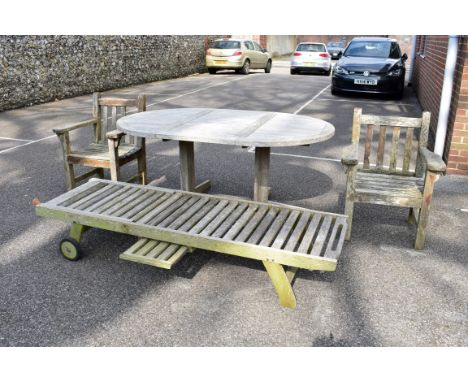 A teak garden table, 181 x 120cm; together with a pair of teak armchairs and a teak lounge chair.Collection of this lot is st