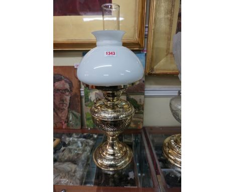 A brass oil lamp, with opaque glass shade, height excluding chimney 46cm. 