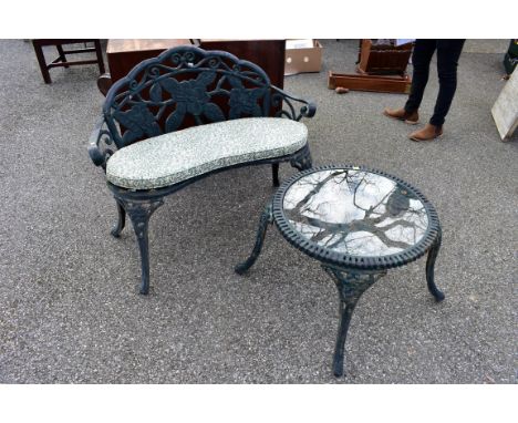 A cast iron kidney shaped garden bench; together with a matching table having glass top, 52 x 60cm.Collection of this lot is 