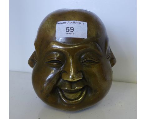 Bronze Buddha head with four different facial expressions