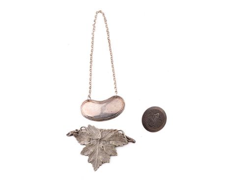 A silver bottle decanter label, Sheffield 1993, without name, a silver button and a white metal 'RUM' label (3).  