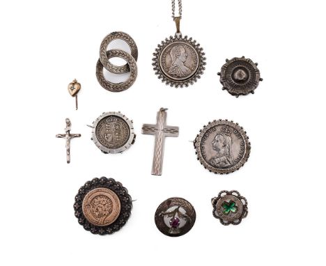 A collection of silver and silver coloured jewellery to include Victorian coin brooches, a cross pendant, and others to inclu