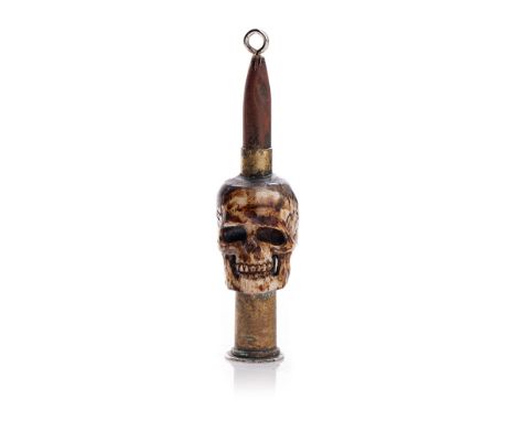 Vintage Trench Art of a carved bone in the form of a skull with an ammunition shell, 9cm tall, mounted on a 3d piece.  