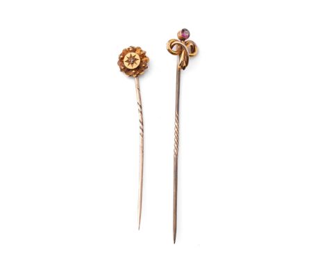 A pair of 9ct gold (tests as 9ct or better) stick pins, one set with amethyst, the other with diamond, with base metal pins, 