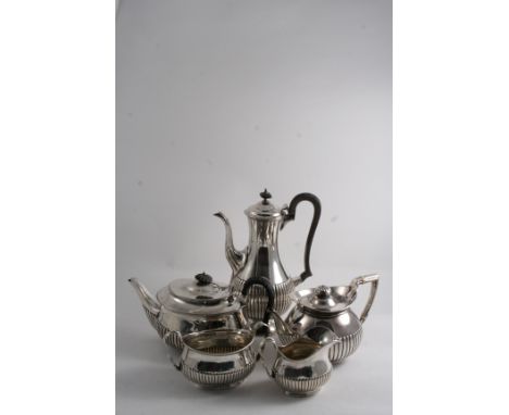 A VICTORIAN THREE-PIECE TEA SET oval with part-fluted decoration, crested, and a baluster coffee pot of a similar form, all b