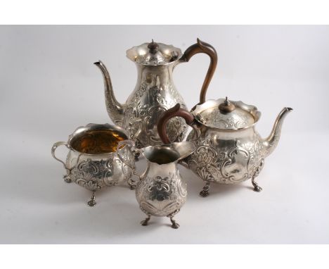 A LATE VICTORIAN/EDWARDIAN ASSEMBLED FOUR-PIECE TEA & COFFEE SERVICE with embossed circular bodies, four feet & shaped rims, 