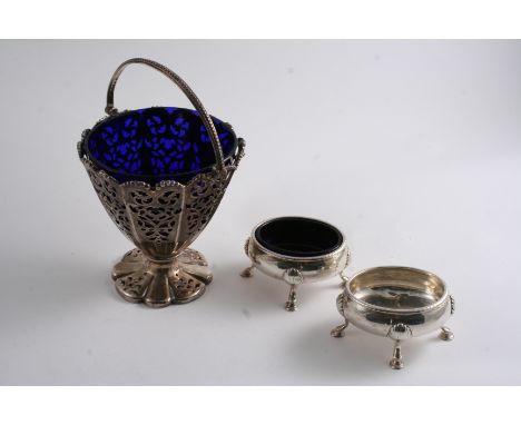 A VICTORIAN SWING HANDLE SUGAR BASKET (blue glass liner) by H. Wilkinson & Co., Sheffield 1850, and a pair of George III oval