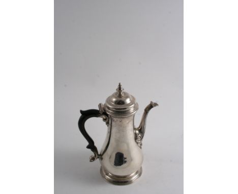 A GEORGE III PLAIN BALUSTER COFFEE POT with a spreading foot, domed cover & knop finial, by Thomas Whipham, London 1752; 9.25
