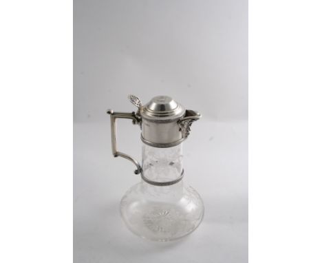 A VICTORIAN MOUNTED CLEAR GLASS CLARET JUG with a star-cut base, the baluster body cut with trailing, wild roses, engraved on