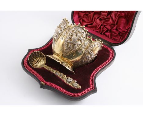 A LATE VICTORIAN PARCELGILT SUGAR BOWL & SIFTER LADLE with embossed and chased decoration, by J. Wakely & F.C. Wheeler, Londo
