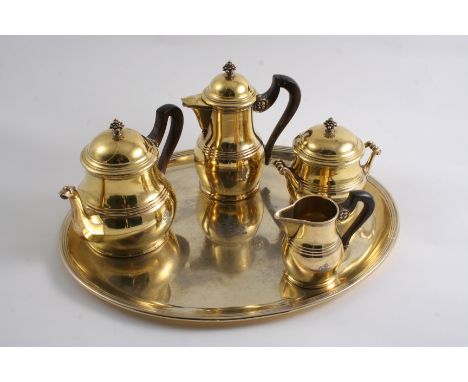 A SMALL EARLY 20TH CENTURY FRENCH SILVERGILT TEA SERVICE including tea pot, hot water jug, milk jug & sugar bowl (with a deta