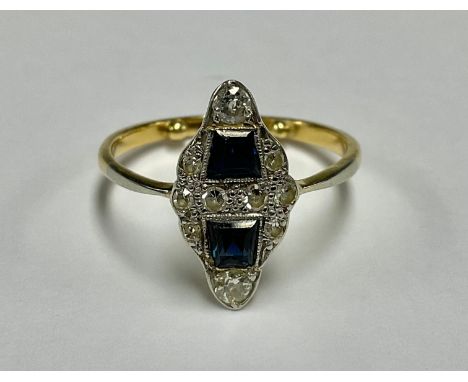 An Art Deco 18ct gold and platinum navette shaped diamond and sapphire ring, the pair of sapphires surrounded by an arrangeme