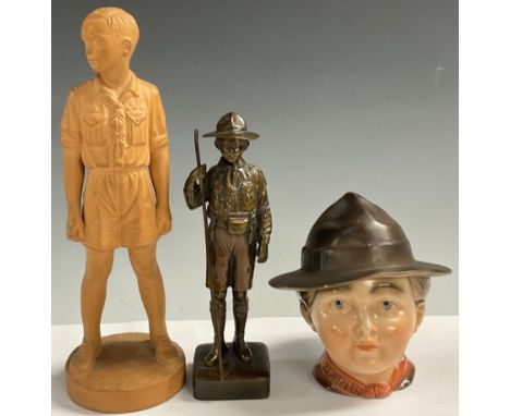 An early 20th century dark patinated bronze, of a Boy Scout, 19.5cm high; a terracotta model, of a Boy Scout, 27cm high, mid 