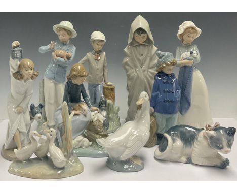 A Spanish porcelain Nao figure, Girl with Puppy, 25cm; Boy With Puppy; kitten; goose; Boy In Duffel Coat; etc (10)