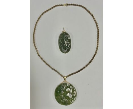 A 9ct gold mounted circular carved jade pendant, 5cm diameter, the chain and mount marked 375, approx. 12g/15g of gold