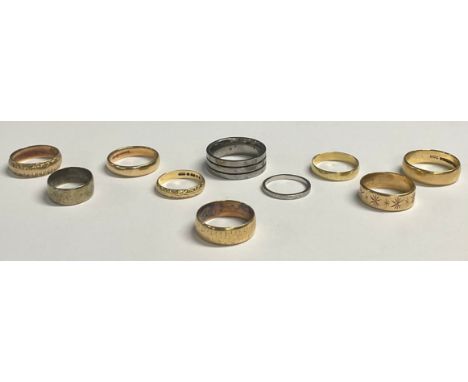 A 9ct gold wedding band, ring size S/T, 4.6g; seven 9ct gold wedding bands, 21g; a platinum ring, size K, 2.2g; a Titanium ri