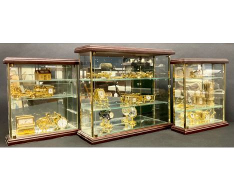 A collection of novelty miniature clocks, including yacht, bicycle, fire engine, racing car, bi-plane, steam train, piano, gl