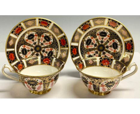 A pair of Royal Crown Derby Imari 1128 pattern tea cups and saucers, printed marks, first quality