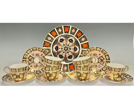A set of six Royal Crown Derby Imari palette 2451 pattern teacups and saucers; an 1128 pattern dinner plate