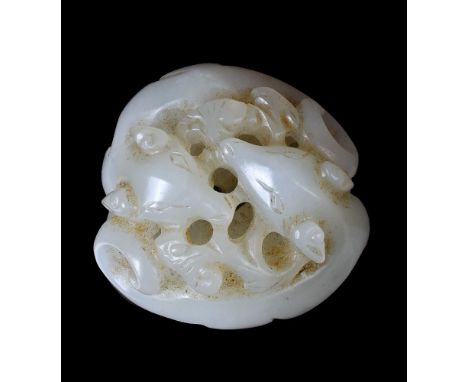 A Chinese white jade carving of two dogs, Qing Dynasty, carved in the round to depict two dogs with long curly tails, chasing