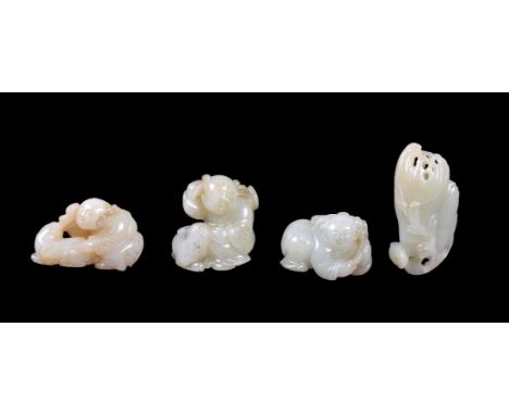 Four Chinese celadon jade carvings, Qing Dynasty, 19th century, including two carvings of figures with dogs and another kneel