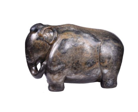 A Chinese brown and celadon jade Elephant, late Ming or Qing Dynasty, with white and black inclusions, carved and incised det