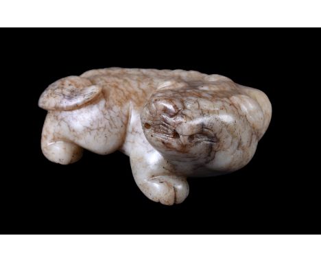 A Chinese mottled grey jade mythical beast, Ming Dynasty, the horned recumbent animal is carved with its cloven hooves tucked