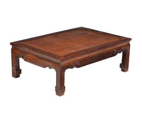 A Chinese Hongmu low table, Kang, Qing Dynasty, of rectangular form, supported on four short bracket legs, inset top, rich pa