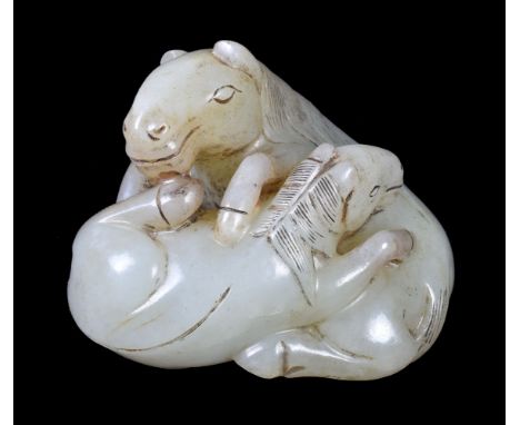 A Chinese celadon jade ‘horse and foal’ group, Qing dynasty, naturalistically carved depicting one horse with its forelegs re