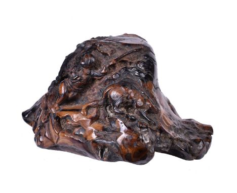 ϒA Chinese 'black coral' or 'root amber' hunting scene carving, Qing Dynasty, 19th century, the irregularly shaped amber-like