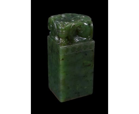 A Chinese spinach jade lion seal, of square section and incised key-fret band, 6.5cm high x 3cm x 2.6cm 青玉印