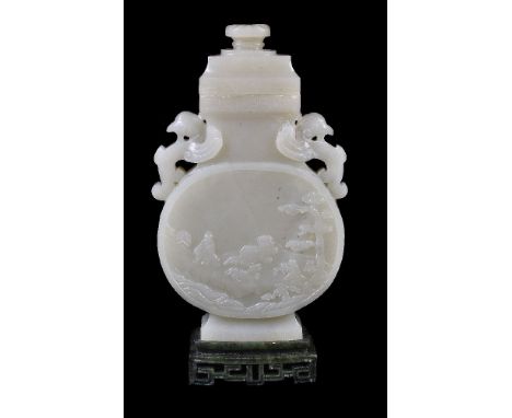 A Chinese pale celadon jade vase on spinach green jade stand, late 19th or 20th century, the flattened body with winged handl