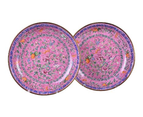 A pair of Chinese canton enamel ‘longevity’ dishes, circa 1800, each decorated with bats flying amid auspicious fruiting and 