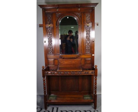 A Victorian oak hall stand, with central mirror over a pair of stick stands and glove box, on block turned supports, 102cm wi