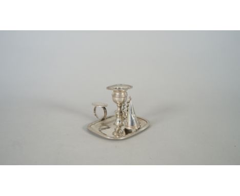 A George IV silver small chamber candlestick, of curved rectangular form, with a loop shaped handle and a detachable snuffing