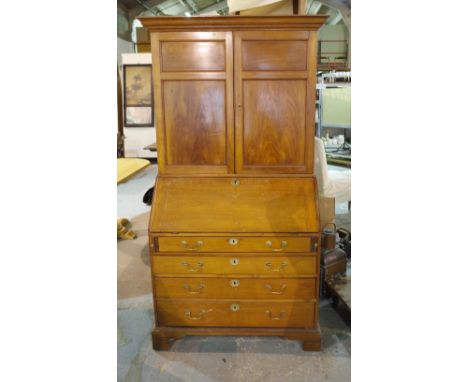 A George III satinwood bureau bookcase, the pair of panel doors over fitted interior and with four long graduated drawers on 