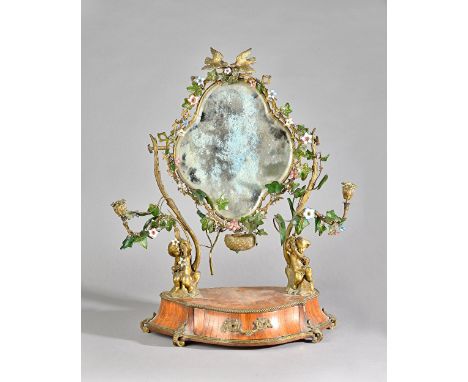 A 19th century French toilet mirror, the bevelled plate mounted with trailing glass and enamel flowers on ormolu candelabra s