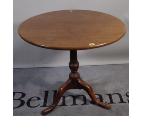 A George III mahogany tripod table on tapering turned column and three downswept supports, 77cm diameter x 72cm high. 