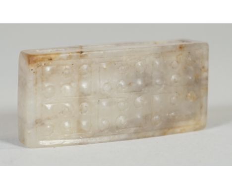 A Chinese jade rectangular sword slide, possibly Han dynasty, the upper surface carved with a `grain' pattern, the stone of g