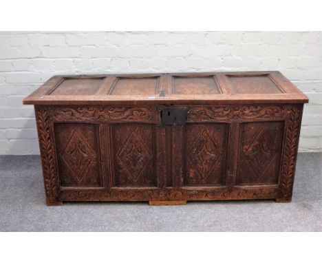 A 17th century oak coffer with four panel lid over four panel front, 139cm wide x 59cm high. 