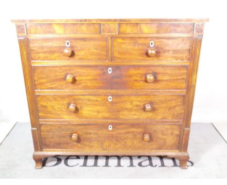 A Regency mahogany chest with a pair of hidden frieze drawers over two short and three long drawers, on ogee bracket feet, 11