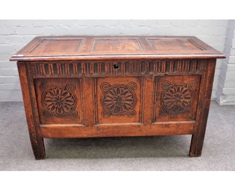 A 17th century oak coffer with triple panel lid over carved triple panel front on stile feet, 123cm wide x 73cm high. 