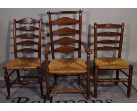 A matched set of nine oak Lancashire ladder back dining chairs to include one carver, (9). 