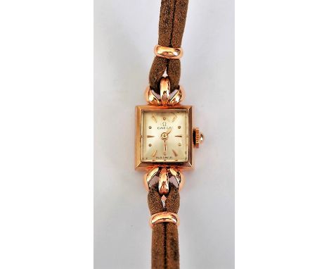 An Omega gold rectangular cased lady's wristwatch, the signed silvered dial with gilt dot and arrow shaped numerals, fitted t