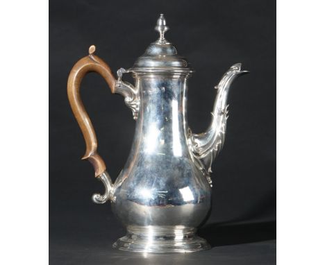 A George III silver coffee pot of baluster form, the hinged lid with an associated detachable acorn shaped finial, later repl