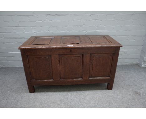 A 17th century oak coffer with triple panel lid and front, on stile feet, 105cm wide x 55cm high.
