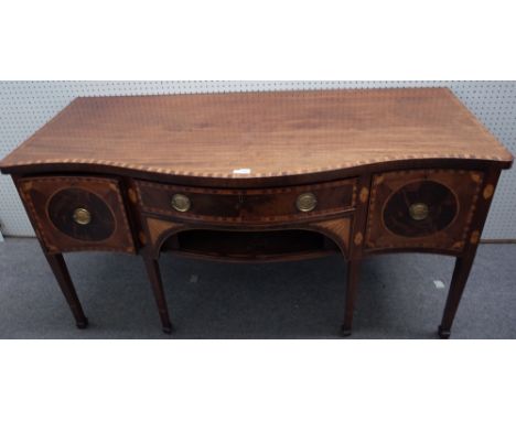 A George III inlaid mahogany serpentine sideboard, with three frieze drawers over tambour panel, on tapering square supports,
