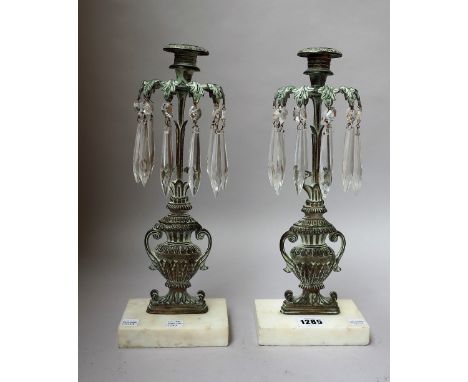 A pair of Georgian style gilt metal candlestick lustres of pierced urn form on a white marble plinth, 33cm high, (2). 